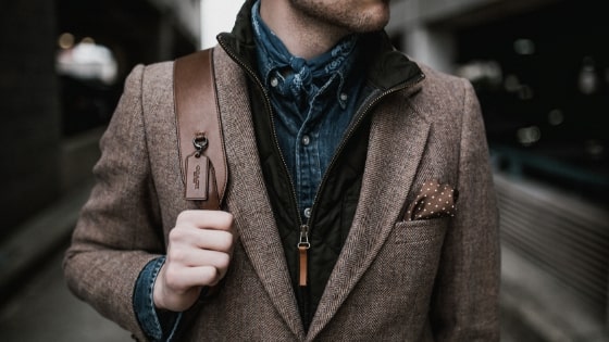 man in blazer with backpack