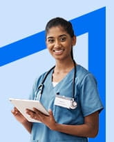 Women in blue scrubs wearing stethoscope and using a tablet.