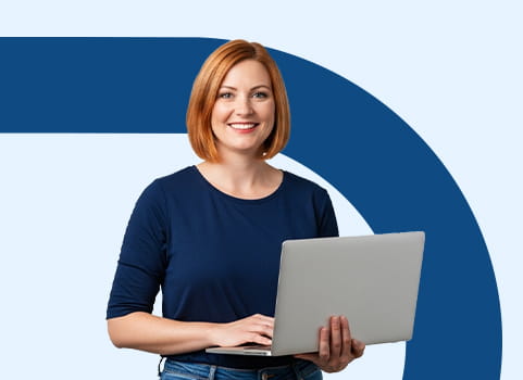 Woman with read hair in navy blue shirt holding silver laptop computer.