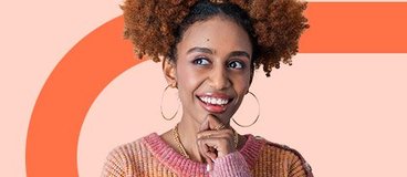girl in pink and orange sweater pondering.
