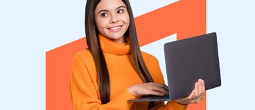 girl in orange turtleneck holding a laptop.