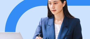 Women in blazer using laptop.