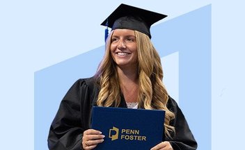 woman in cap and gown holding diploma.