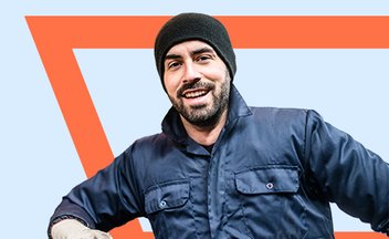 smiling man wearing gloves and a beanie.