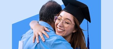 Girl in grad cap hugging older man.