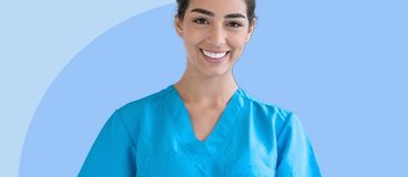 Medical assistant in blue scrubs on blue background.