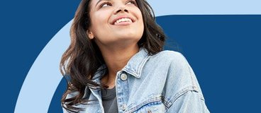 Young woman gazing upward with an optimistic look on her face.