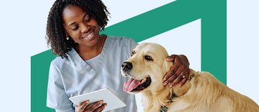 Woman in light blue scrubs with dog.