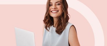 Woman in sleeveless shirt holding laptop.