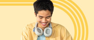 Teen boy in yellow shirt using tablet.