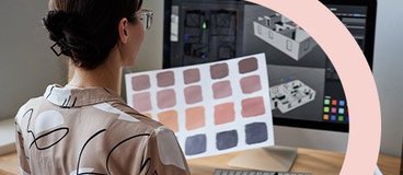 Woman using color palette and digital design tools.
