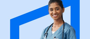 Women in blue scrubs wearing stethoscope and using a tablet.