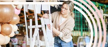 Woman setting up decor for wedding.