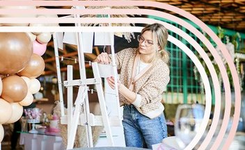 Woman setting up decor for wedding.