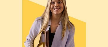 woman in blazer holding file folders.