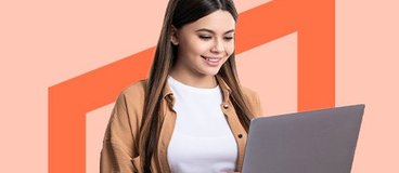 girl using silver laptop on orange background.