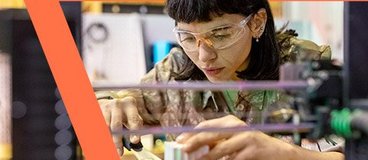 Woman in safety goggles working with 3D printing.