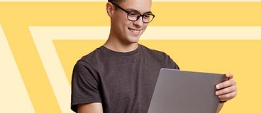young man looking at tablet on yellow and orange background.