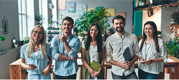 Group of men and women at work posing for photo.