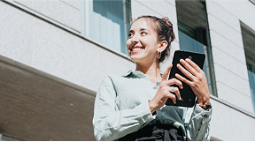 Women outside with tablet in hand.
