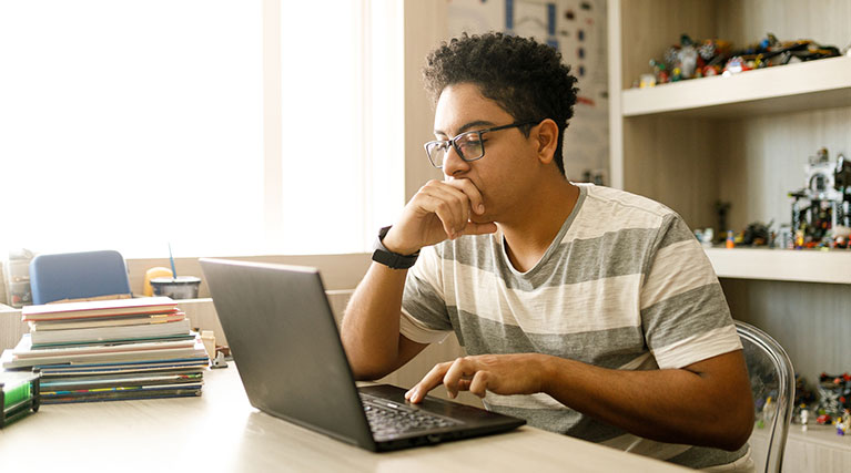 student studying on laptop.