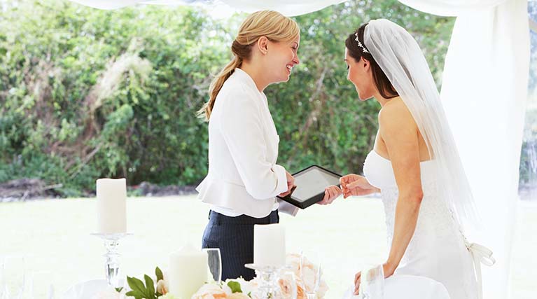 wedding planner talks to bride.