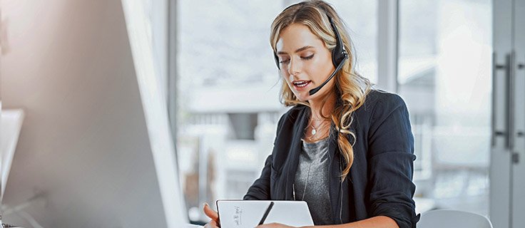 administrative assistant talks on headset.
