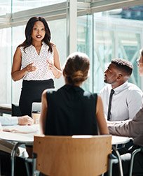business woman speaks during meeting.