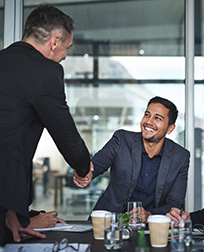business man shakes hand during meeting.