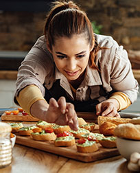 caterer preparing food in kitchen.