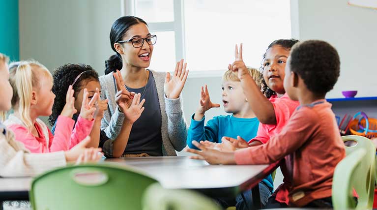 child care professional teaching with students.