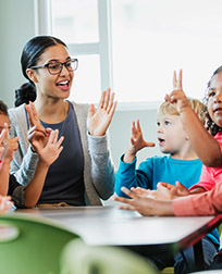 child care professional teaching with students.