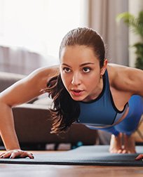 woman practicing yoga plank pose.