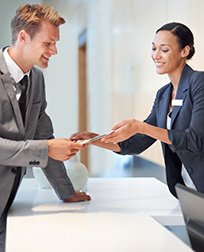 guest service agent shows guest brochure.