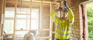 electrician working on home remodel electrical wiring.