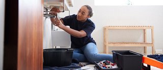 plumber working on bathroom sink.