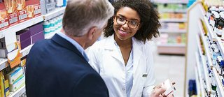 pharmacist assisting a customer.