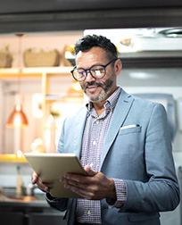 restaurant manager reading notes in kitchen.