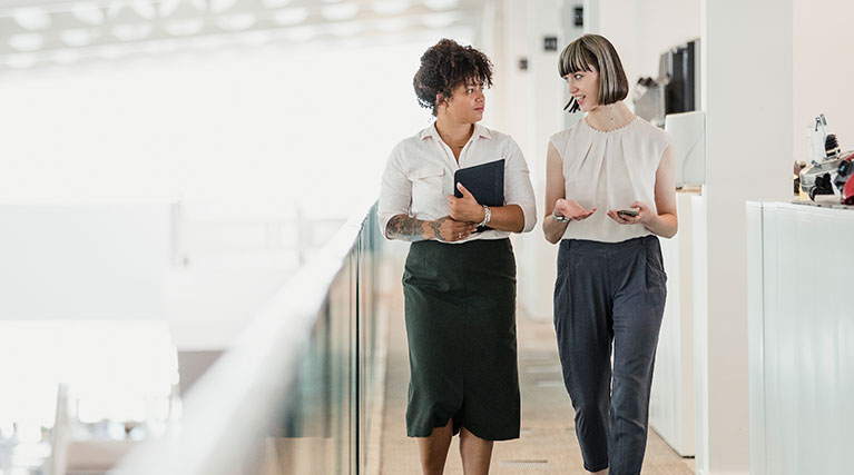 two human resource professionals talking at work.