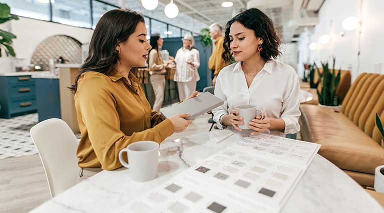 interior designer talks to client in a showroom.