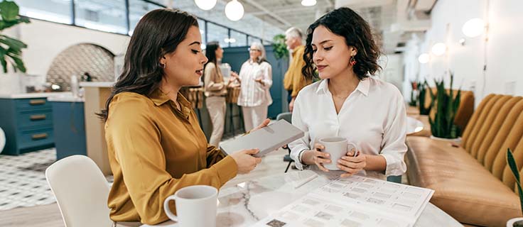 interior designer talks to client in a showroom.