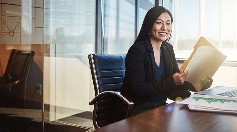 legal secretary opening folder at desk.