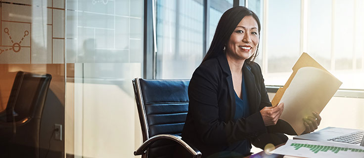 legal secretary opening folder at desk.