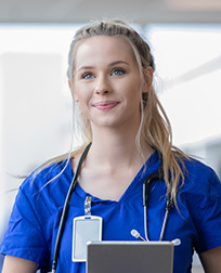 medical assistant wearing scrubs and stethoscope.