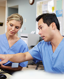 two medical terminologist reading computer tablet.