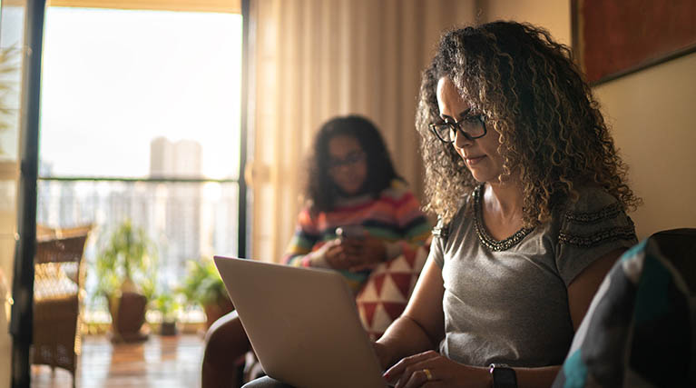 woman using laptop in living room.