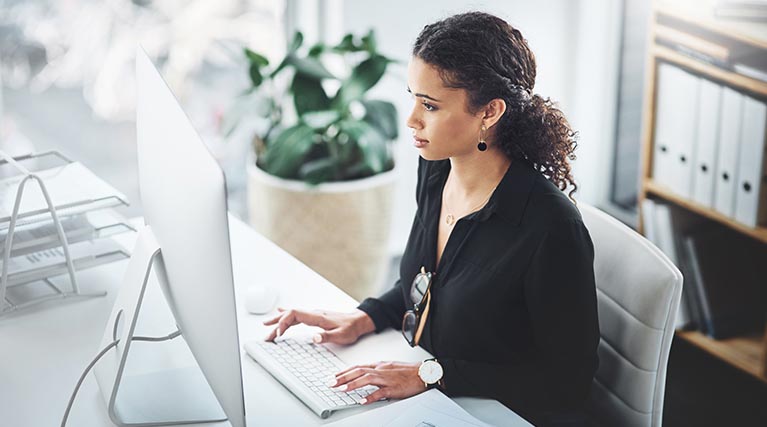 payroll clerk working at a computer.