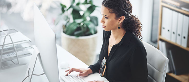 payroll clerk working at a computer.