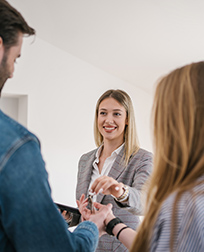 property manager handing keys to new tenants.