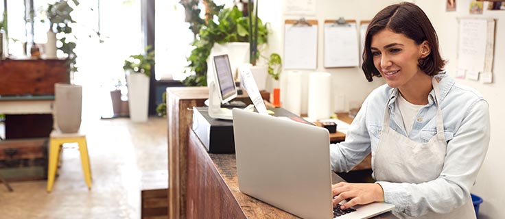 small business owner checking laptop.